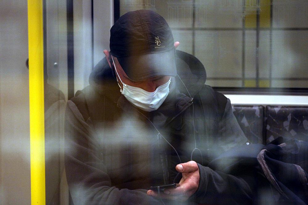 Mann mit Schutzmaske in einer U-Bahn